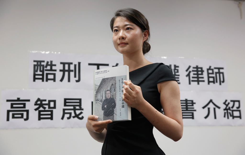 Grace Geng, a filha de Gao Zhisheng, um dos mais proeminentes advogados de direitos humanos da China, segura o livro recém-publicado pelo pai, durante uma conferência de imprensa em Hong Kong em 14 de junho de 2016. (AP Photo/Kin Cheung)