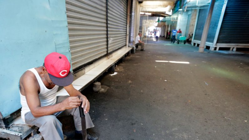 Homem se senta ao lado de barracas fechadas durante greve geral de 24 horas em todo o país no mercado oriental de Manágua em 7 de setembro de 2018 (INTI OCON / AFP / Getty Images)
