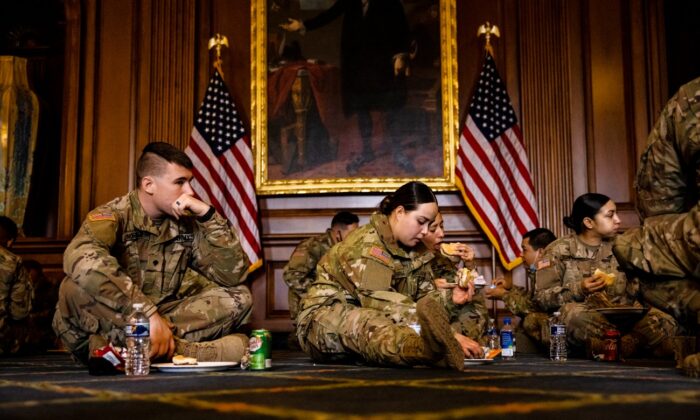 As tropas da Guarda Nacional da Califórnia desfrutam do café da manhã oferecido pelo líder da minoria na Câmara, Kevin McCarthy (R-Calif.) Como uma demonstração de gratidão no Rayburn Room no Capitólio dos EUA em Washington, em 12 de fevereiro de 2021 (Samuel Corum / Getty Images)
