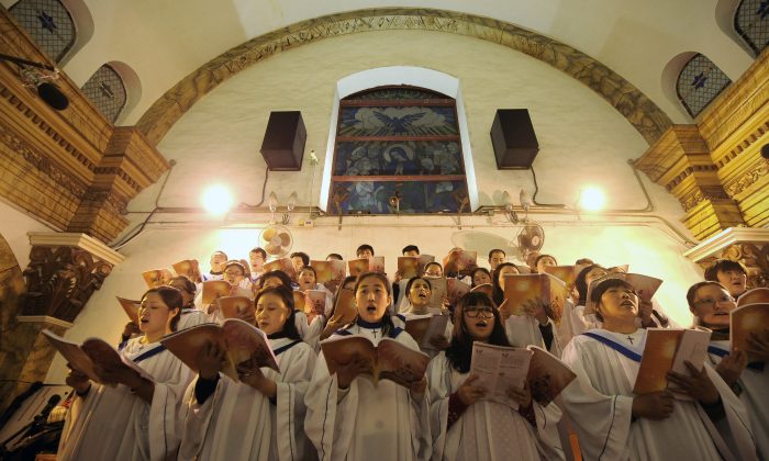 Adoradores chineses cantam hinos durante a missa da véspera de Natal em uma igreja católica aprovada pelo estado em Pequim em 25 de dezembro de 2012 (Wang Zhao / AFP / Getty Images)

