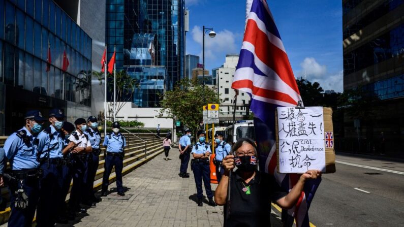 Alexandra Wong (R), uma ativista conhecida como Vovó Wong, segura uma bandeira da Union Jack britânica em frente ao Tribunal Distrital de Hong Kong em 28 de maio de 2021, enquanto nove ativistas pró-democracia aguardam a sentença sob a acusação de reunião não autorizada. No Dia Nacional da China. em 1 de outubro de 2019 (Anthony Wallace / AFP via Getty Images)
 