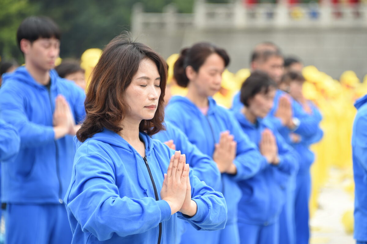 Praticantes do Falun Gong realizam os exercícios em um evento que celebra o Dia Mundial do Falun Dafa na cidade de Taipei, em Taiwan, no dia 1º de maio de 2021 (Sun Hsiang-yi / The Epoch Times)