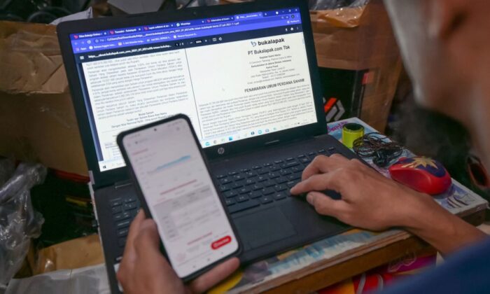 Uma foto de arquivo mostra um homem usando um laptop com o sistema operacional Microsoft Windows (BAY ISMOYO/AFP via Getty Images)