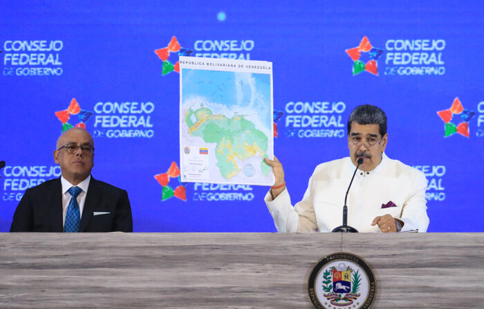 Fotografia cedida pelo Palácio Miraflores de Nicolás Maduro, segurando um mapa da Venezuela com a área da Guiana, em evento governamental em Caracas (EFE/Palácio Miraflores)