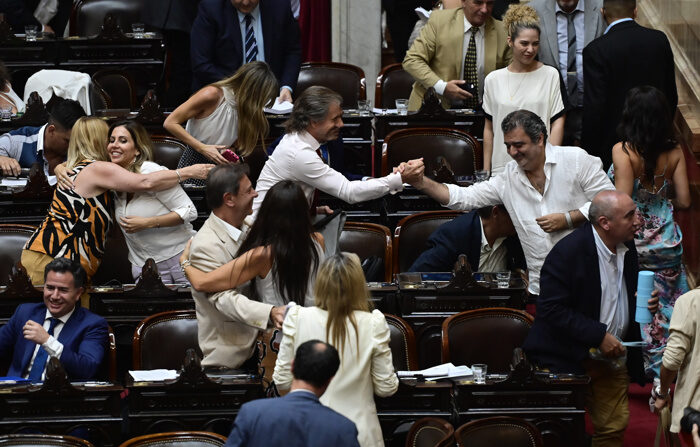 Deputados argentinos se cumprimentam após a aprovação geral da "lei omnibus", promovida pelo governo de Javier Milei, hoje, em Buenos Aires, Argentina (EFE/ Matías Martín Campaya).