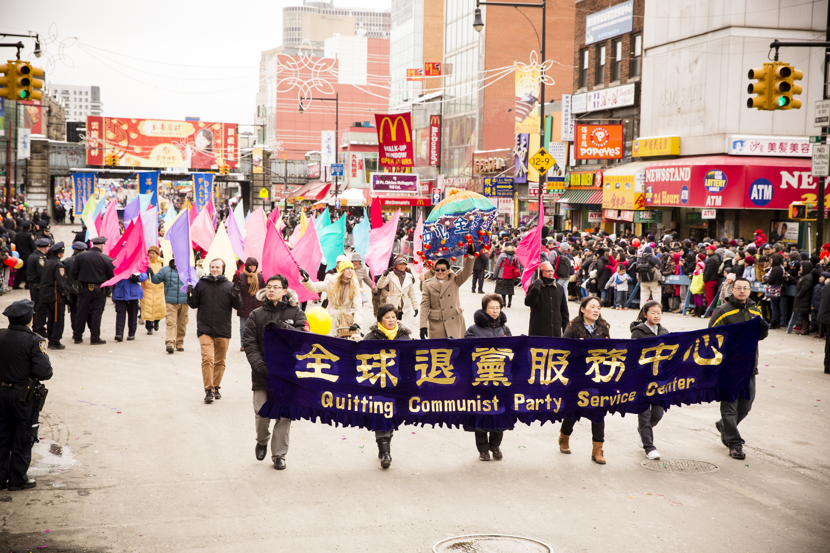 People marching for the Global Service Center for Quitting the CCP participate in the Chinese New Year parade in Flushing, New York, on Feb. 8, 2014. (Edward Dai/Epoch Times)